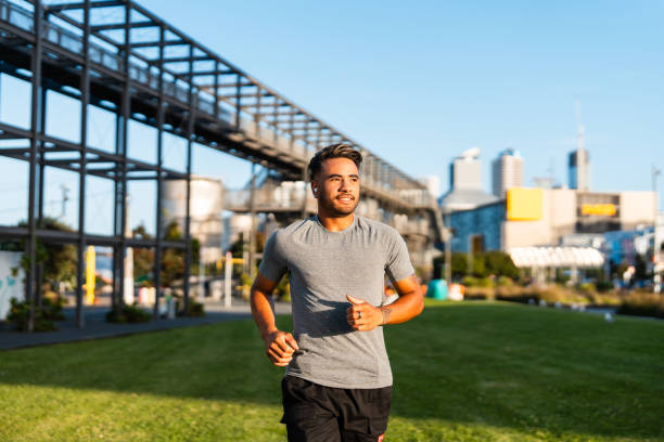 Young Maori couple in casual clothing running outdoor in  Auckland city, New Zealand.