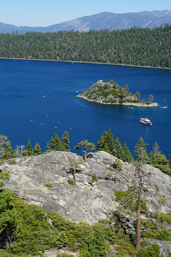View of the tea house on Fannette Island at Emerald Bay in Lake Tahoe, California, from the viewpoint at Vikingsholm parking lot on a sunny day