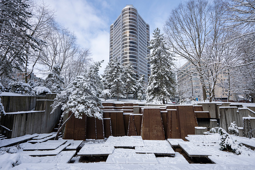 Portland, OR, USA - Feb 23, 2023: Keller Fountain Park in downtown Portland, Oregon, after heavy snowfall in winter. Designed by Angela Danadjieva, the forecourt fountain was completed in 1970.