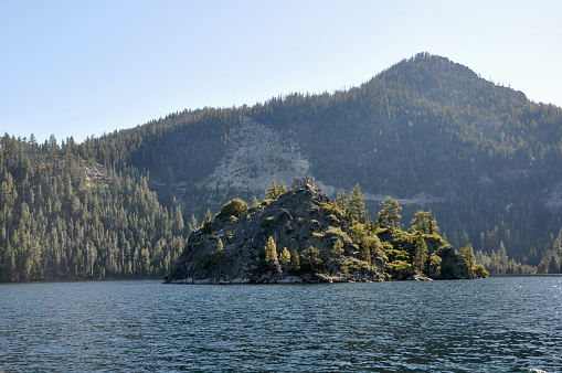 View of the ruins of the tea house on Fannette Island at Emerald Bay in Lake Tahoe, California, from a boat on a sunny day