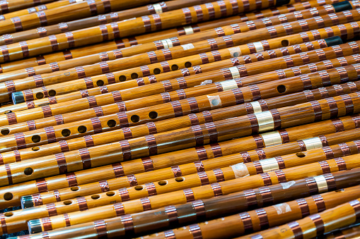 (Selective focus) Stunning view of a defocused bamboo forest during a sunny day. Arashiyama Bamboo Grove, Kyoto, Japan. Natural, green background with copy space.