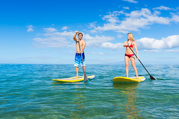 istock Couple in yellow paddle boards on the Hawaiian waters 184900821
