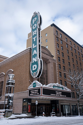 Portland, OR, USA - Feb 23, 2023: Arlene Schnitzer Concert Hall, a historic theater building and performing arts center with the iconic Portland sign, in downtown Portland, Oregon, in winter.