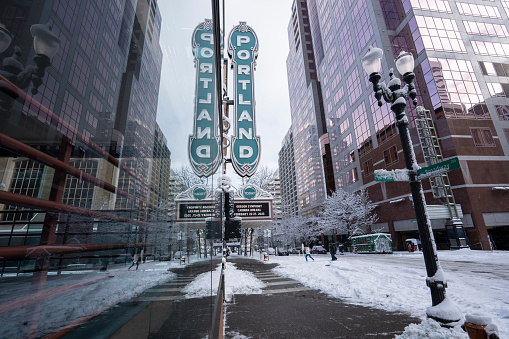 Portland, OR, USA - Feb 23, 2023: The iconic Portland sign at the Arlene Schnitzer Concert Hall, a historic theater building on Broadway in downtown Portland, Oregon, after snowfall in winter.