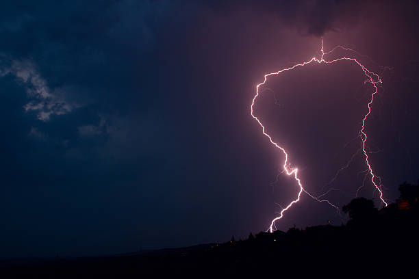 istock Lightning bolt striking in the sky from clouds 184902394