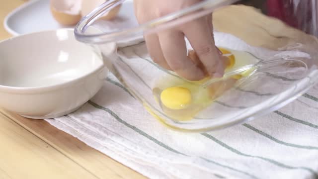 preparing homemade omelette mixing with whisk eggs.
