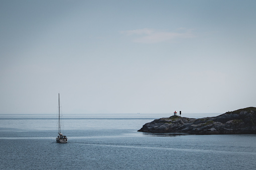 Sailboat in the archipelago of Stockholm, Sweden. People moving on the boat.