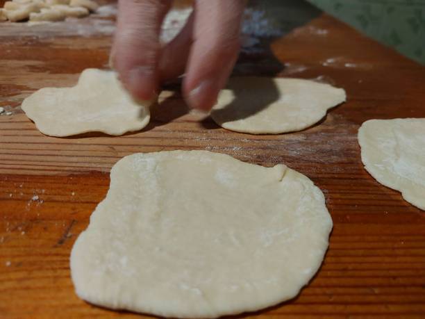 istock Mixing and cutting dough for making flour products 1849073088