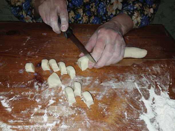 istock Mixing and cutting dough for making flour products 1849073337