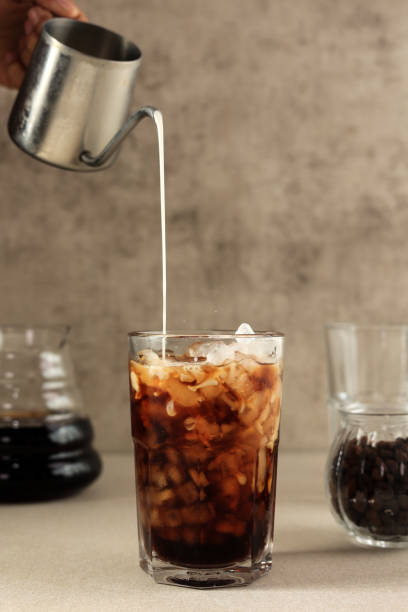 istock Iced Latte Coffee in A Glass with Pouring Milk 1849081614