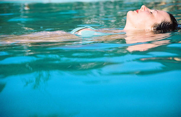 istock Young woman relaxing in swimming pool 184908268