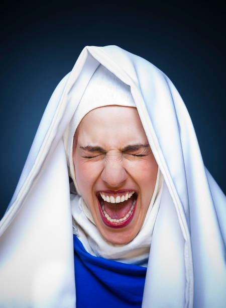 Screaming Well Beautiful screaming nun. Studio shooting session. angry nun stock pictures, royalty-free photos & images