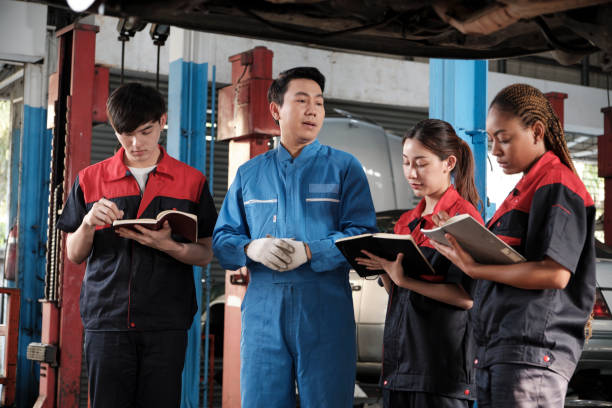 istock A supervisor engineer is training mechanic workers about car repair at a garage. 1849091741