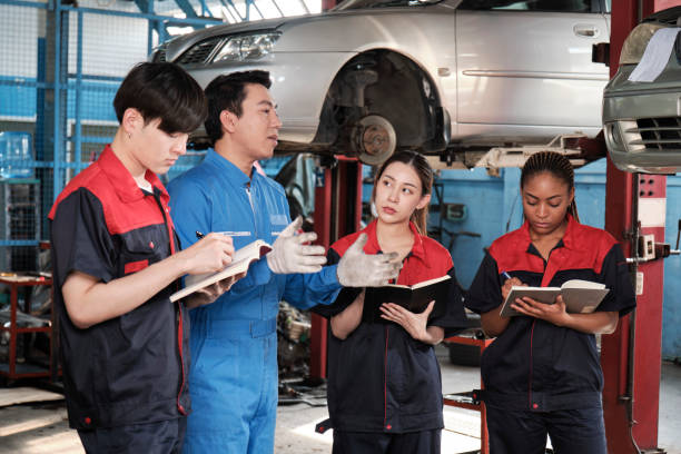istock A supervisor engineer is training mechanic workers about car repair at a garage. 1849092872