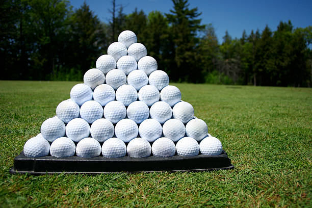 Golf ball on tee on green grass of golf course background, backgrounds for banner foth copy space for text