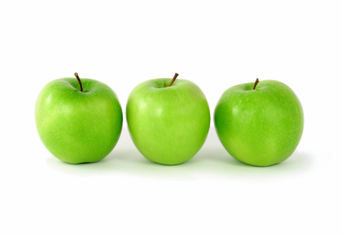 Three green apples on white background