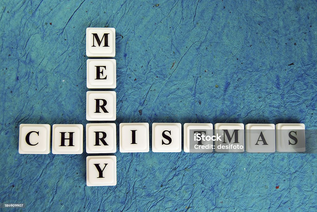 MERRY CHRISTMAS Play blocks - MERRY CHRISTMAS - on a rough old rough blue paper background. Quite even focus - more towards right starting from intersection. Alphabet Stock Photo