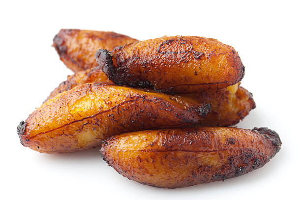 Fried Maduro Plantain Fried Maduro Sweet Plantain on white background fried plantain stock pictures, royalty-free photos & images