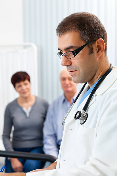 istock Doctor with patient's in doctor's office 184910289
