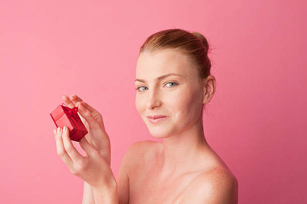 istock young woman receiving a gift 184910540