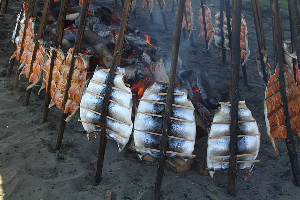 Opened smokehouses with fresh hot-smoked red sea bass and mackerels, fair in the city of the Baltic Sea coast