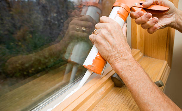 Hands Applying Weather Seal Caulk to Window Frame  sealant photos stock pictures, royalty-free photos & images