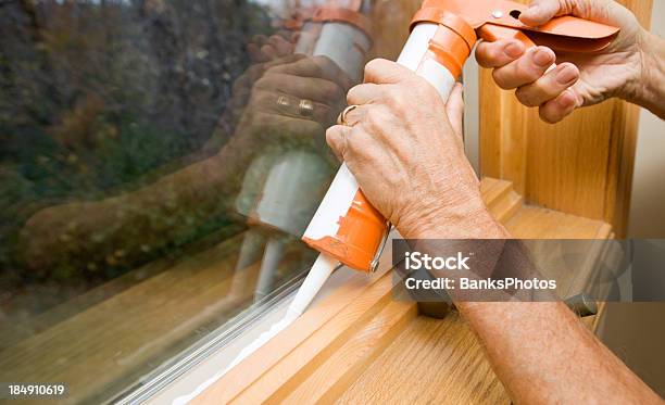 Hands Applying Weather Seal Caulk To Window Frame Stock Photo - Download Image Now - Caulk Gun, Window, Insulation