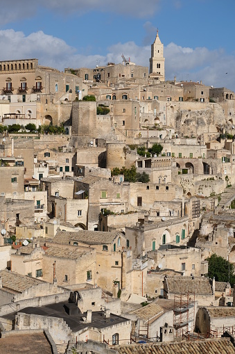 Panorama of houses and of the Sassi of Matera with roofs and streets. Blue sky with