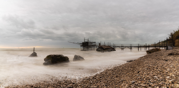 Trabocco Punto Le Morge on a rainy day under a cloudy sky long exposure on the Abruzzo Coast