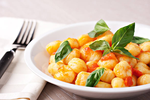 Gnocchi with tomato mozzarella and basil stock photo