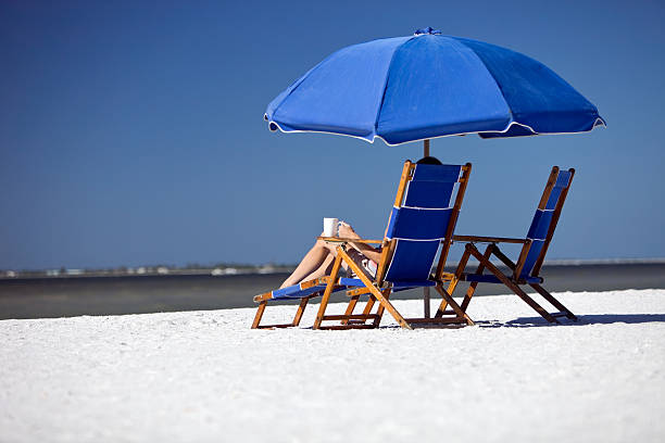 Female Relaxing on Beach Chair with Coffee Cup  fort meyers beach stock pictures, royalty-free photos & images