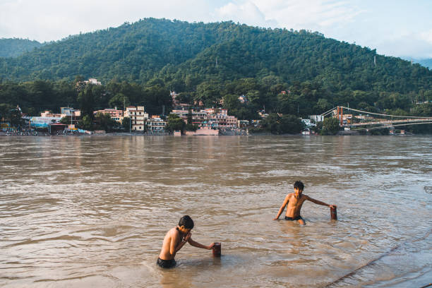 rishikesh, india. 10th september, 2023: hindu people having a holy bath at ganges river bank