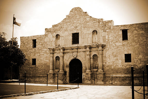 San Antonio Texas. Many believe The Alamo to be the symbol of historic courage against inummerable odds. Settlers here fought of the Mexican Army for 13 days in early 1836. One of the great stories in Texas and American history. This is the original facade of the chapel. Texas flag unfurled.