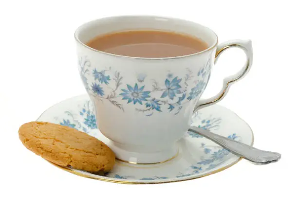 Photo of Cup of tea with a cookie biscuit