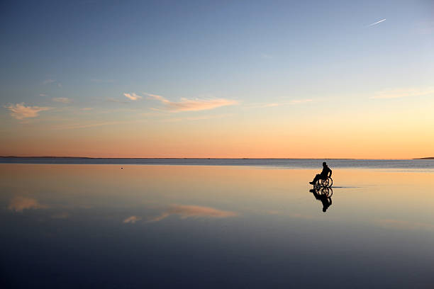 istock driving wheelchair though the lake 184912657