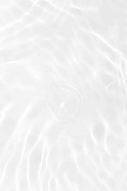 istock White water with ripples on the surface. Defocus blurred transparent white colored clear calm water surface texture with splashes and bubbles. Water waves with shining pattern texture background. 1849129832