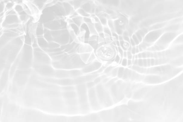 istock White water with ripples on the surface. Defocus blurred transparent white colored clear calm water surface texture with splashes and bubbles. Water waves with shining pattern texture background. 1849130836
