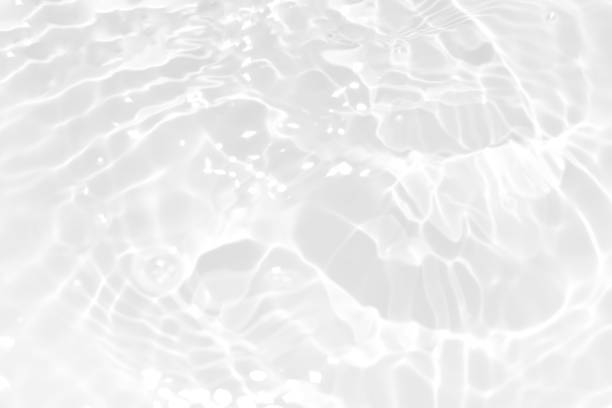 istock White water with ripples on the surface. Defocus blurred transparent white colored clear calm water surface texture with splashes and bubbles. Water waves with shining pattern texture background. 1849130860