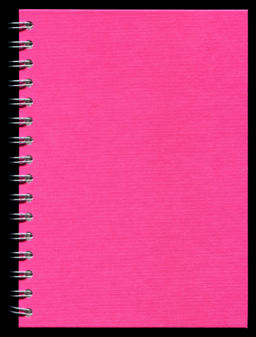 Pink spiral notebook cover paper textured background isolated on black.