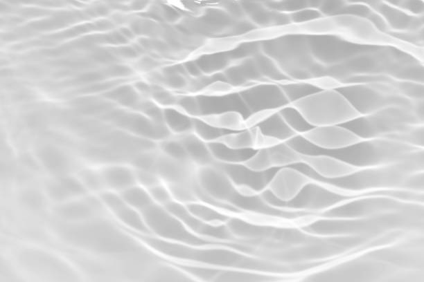 istock White water with ripples on the surface. Defocus blurred transparent white colored clear calm water surface texture with splashes and bubbles. Water waves with shining pattern texture background. 1849131901