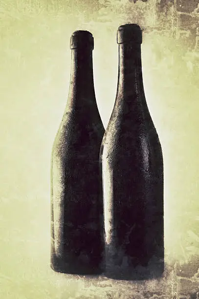 Two old bottles. Vintage style: added texture and age effect.Red wine bottle isolated on white