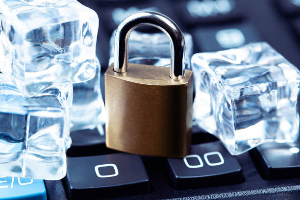 metal lock with ice cube and calculator stock photo