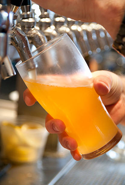 Bartender pouring beer into a glass from the tap