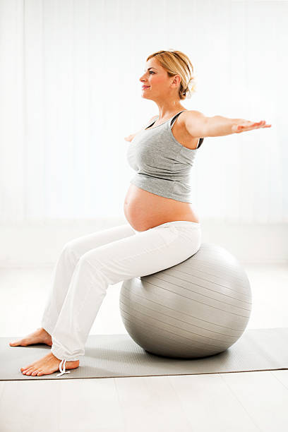 istock Beautiful pregnant woman doing exercises 184913738