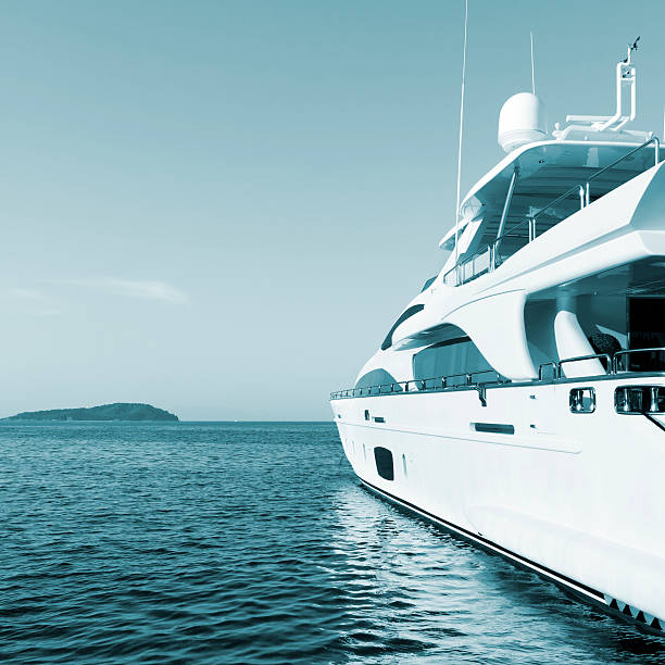 Yacht in the islands. Perfect shape. Summer sky. stock photo