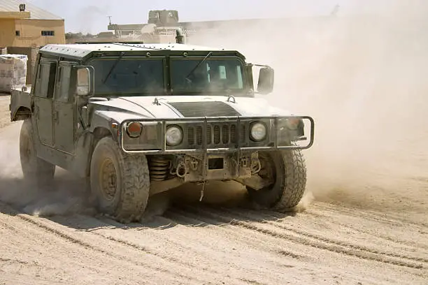 U.S. HMMWV kicking up dust in Iraq. Please see similar images here;