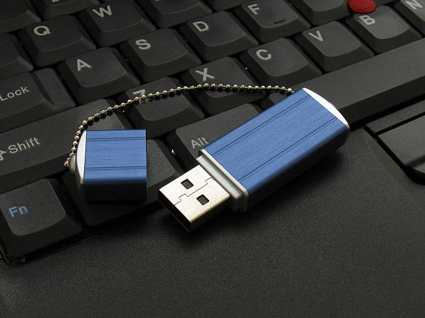 USB memory drive on keyboard USB memory device / stick / drive on keyboard usb stick photos stock pictures, royalty-free photos & images