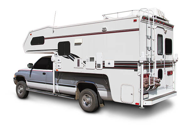 a white truck with a camper mounted on top