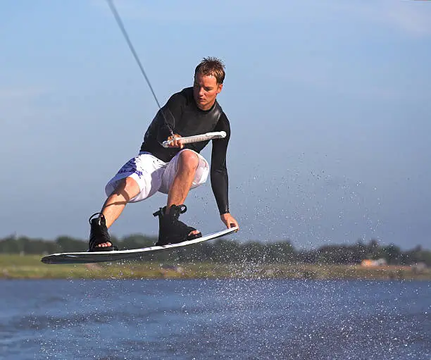 Wakeboarder performing a tailgrab