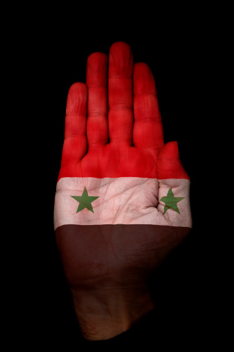 Palm of a hand with the Syrian Flag on it